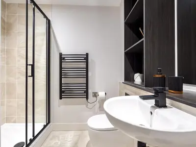 a bathroom with a white sink and a toilet at Pass the Keys Luxury Flat with River Views. 1 Bed. Sleeps 4 in Liverpool