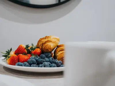 a plate of fruit and pastries on a table at Pass the Keys Luxury Flat with River Views. 1 Bed. Sleeps 4 in Liverpool