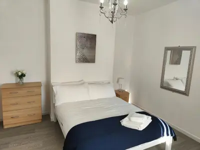a bedroom with a bed with a mirror and a dresser at Home sweet Home, 2 bedrooms apartment in Liverpool