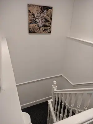 a staircase with a picture of a tiger on the wall at Home sweet Home, 2 bedrooms apartment in Liverpool