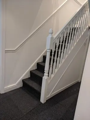 a staircase with white railings and black carpet at Home sweet Home, 2 bedrooms apartment in Liverpool
