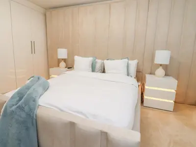 a bedroom with a large white bed and two lamps at Mellings Place in Carnforth