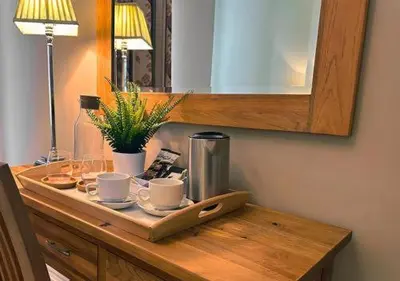 a table with a tray with cups and a coffee maker at Station lounge in Clitheroe