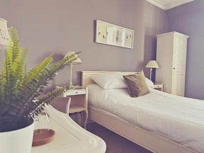 a bedroom with a bed and a desk with a plant at Station lounge in Clitheroe