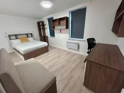 a bedroom with a bed and a desk in a room at For Students Only Myrtle Court in Liverpool in Liverpool