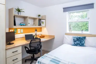 a bedroom with a bed and a desk with a computer at For Students Only Myrtle Court in Liverpool in Liverpool