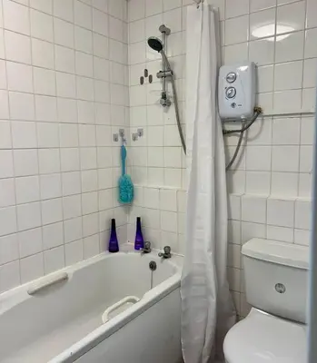 a white bathroom with a tub and a toilet at For Students Only Myrtle Court in Liverpool in Liverpool