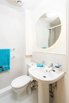 a bathroom with a toilet and a sink and a mirror at For Students Only The Railyard in Liverpool in Liverpool