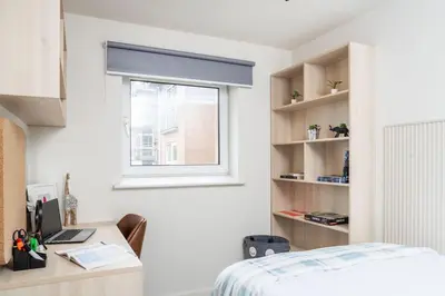 a bedroom with a bed and a desk and a window at For Students Only The Railyard in Liverpool in Liverpool