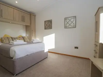 a bedroom with a large bed in a room at Bluebell Lodge in Carnforth