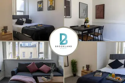 a room with a bed and a couch and a table at One Bedroom Apartment by Brookland Stays Serviced Accommodation Short Lets Blackpool with Free WiFi in Blackpool