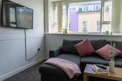 a living room with a couch and a window at One Bedroom Apartment by Brookland Stays Serviced Accommodation Short Lets Blackpool with Free WiFi in Blackpool