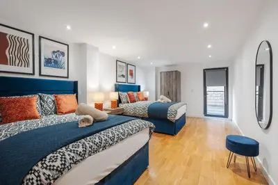 a bedroom with two beds and a mirror at Stunning Central 2 bed Apt, 2 Baths in Liverpool