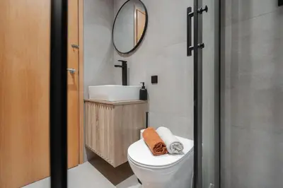 a bathroom with a toilet and a sink and a mirror at Stunning Central 2 bed Apt, 2 Baths in Liverpool