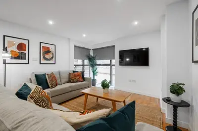 a living room with a couch and a table at Stunning Central 2 bed Apt, 2 Baths in Liverpool