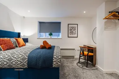 a bedroom with a blue bed and a window at Stunning Central 2 bed Apt, 2 Baths in Liverpool