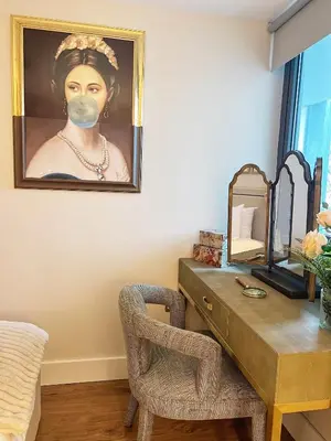 a desk with a painting of a woman with a mask at Central, Stylish 2BR Flat Sleeps 6 with Parking! in Liverpool