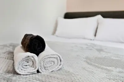 a pile of towels sitting on a bed at Spacious 3B Home, ideal for contractors & family! in Clayton le Moors