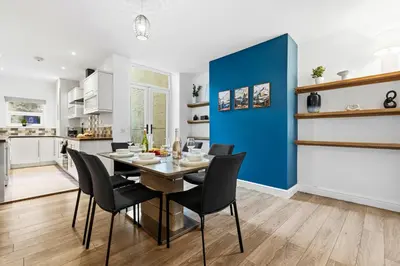 a kitchen and dining room with a table and chairs at Spacious 3B Home, ideal for contractors & family! in Clayton le Moors