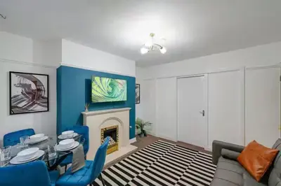 a living room with a couch and a fireplace at Home in Anfield in Liverpool