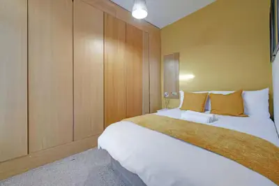 a hotel room with two beds and wooden walls at Home in Anfield in Liverpool