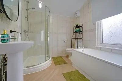 a bathroom with a sink and a tub and a toilet at Home in Anfield in Liverpool
