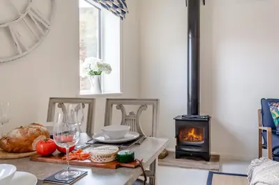 a living room with a table with a wood stove at 2 Bed in Dunsop Bridge oc-w33524 in Newton