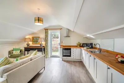 a kitchen and living room with a couch and a table at 2 Bed in Dunsop Bridge oc-w33525 in Newton