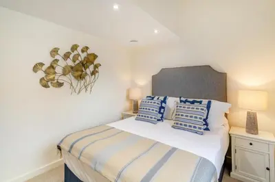 a bedroom with a bed with blue and white pillows at 2 Bed in Dunsop Bridge oc-w33525 in Newton