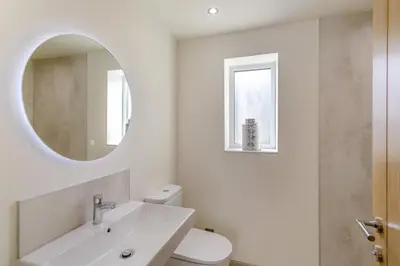 a white bathroom with a sink and a mirror at 2 Bed in Dunsop Bridge oc-w33525 in Newton