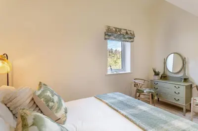a bedroom with a bed and a mirror and a dresser at 2 Bed in Dunsop Bridge oc-w33526 in Newton