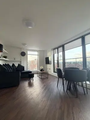 a living room with a couch and a table at Liverpool City Centre - Skyline Apartment in Liverpool