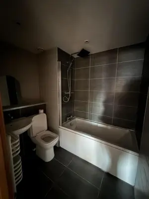 a bathroom with a tub and a toilet and a sink at Liverpool City Centre - Skyline Apartment in Liverpool