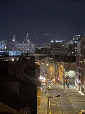 a city at night with street lights and buildings at Liverpool City Centre - Skyline Apartment in Liverpool
