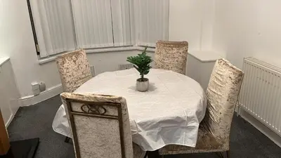 a dining room with a table with a plant on it at Regina Pacis contractor place near the city in Liverpool