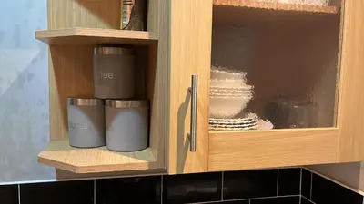 two coffee cups in a cabinet in a kitchen at Regina Pacis contractor place near the city in Liverpool