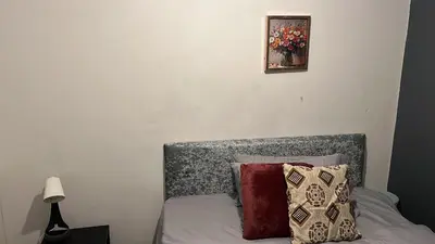 a bed with pillows and a picture on the wall at Regina Pacis contractor place near the city in Liverpool