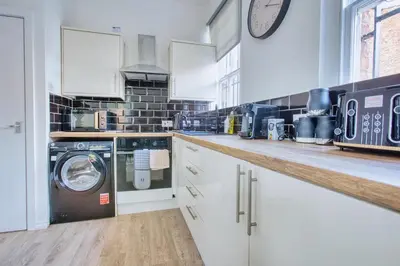 a kitchen with a washer and dryer on a counter at Central 2 beds APT with FREE parking, Sleeps 6 in Liverpool
