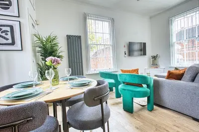 a living room with a table and chairs and a couch at Central 2 beds APT with FREE parking, Sleeps 6 in Liverpool