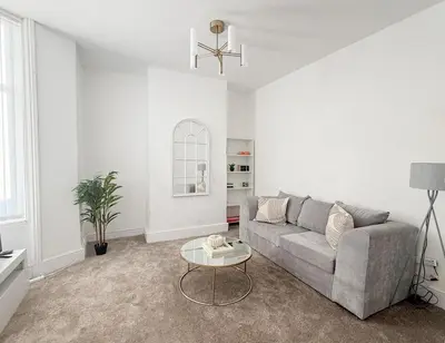 a living room with a couch and a table at Modern 3-Bed House Near Attractions & Beach in Blackpool