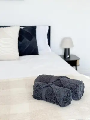 a towel is laying on a bed at Modern 3-Bed House Near Attractions & Beach in Blackpool