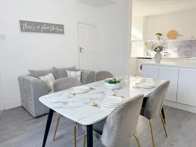 a white dining room table with chairs and a couch at Modern 3-Bed House Near Attractions & Beach in Blackpool