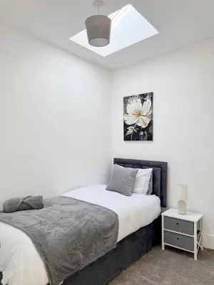a bedroom with a bed and a white ceiling at Modern 3-Bed House Near Attractions & Beach in Blackpool