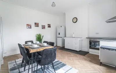 a kitchen with a table and chairs in a room at 5 Bed Stay For Contractors And Families in Morecambe