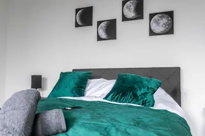 a bedroom with a bed with green pillows at 5 Bed Stay For Contractors And Families in Morecambe
