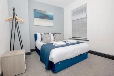 a bedroom with two beds and a window at Delamore Place Cozy Home 3BR near City in Liverpool