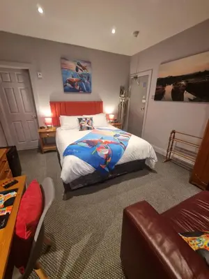 a bedroom with a bed and a couch at Pride Lodge in Blackpool