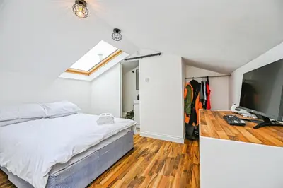 a bedroom with a bed and a flat screen tv at 4 bed house Liverpool L7 in Liverpool
