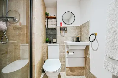 a bathroom with a shower and a toilet and a sink at 4 bed house Liverpool L7 in Liverpool