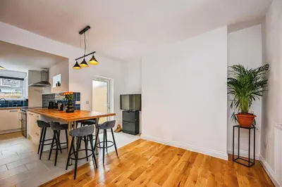 a kitchen and dining room with a table and chairs at 4 bed house Liverpool L7 in Liverpool